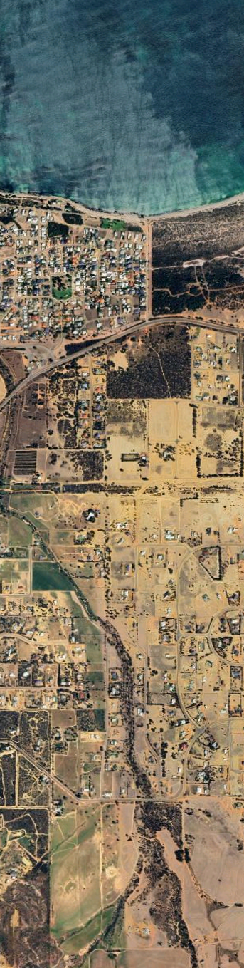 Aerial view of a city layout with roads and buildings.